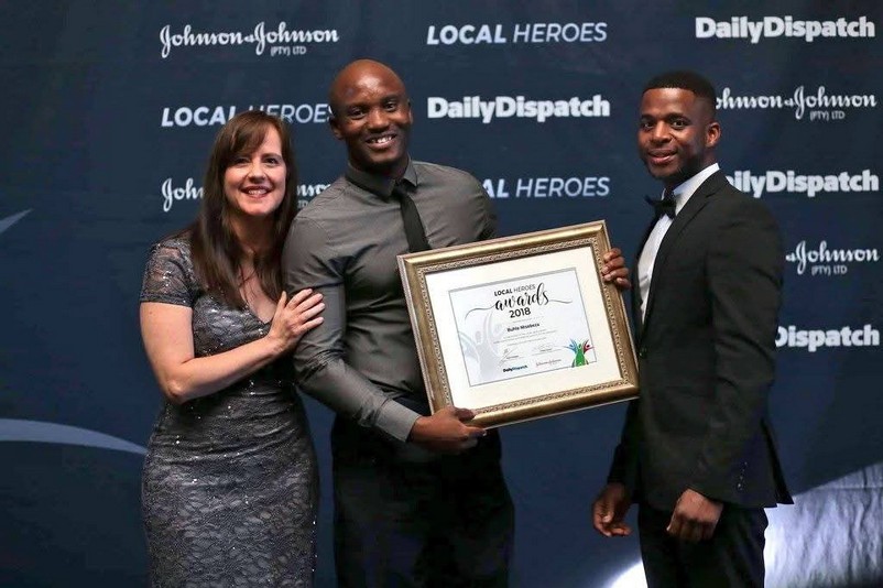 Founder presenting an award at an Olutsha Sports event